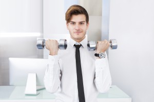Businessman Exercising With Dumbbells
